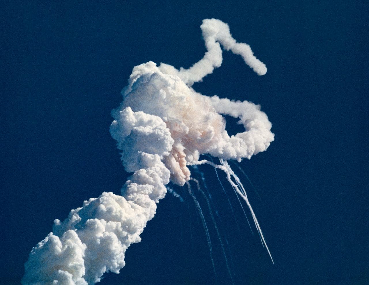 The Challenger shuttle breaking apart 73 seconds after launch on 28 January 1986
