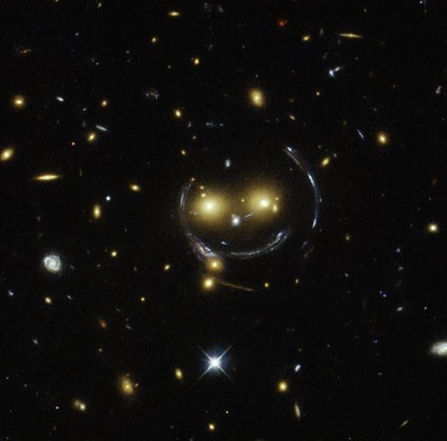 Gravitational lensing effect showing distant galaxies distorted by a massive foreground object
