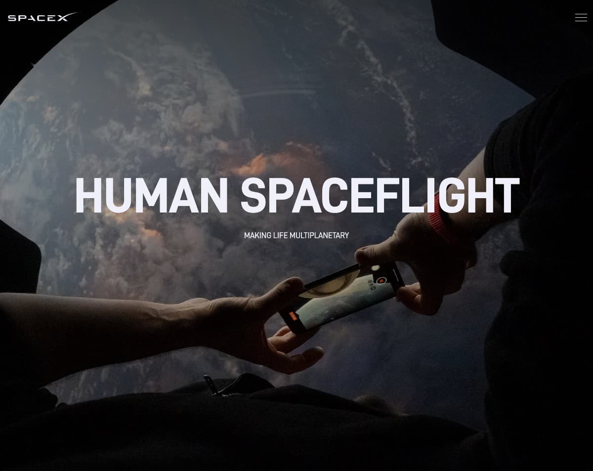 SpaceX Human Spaceflight — Astronaut photographing Earth from Dragon's cupola window