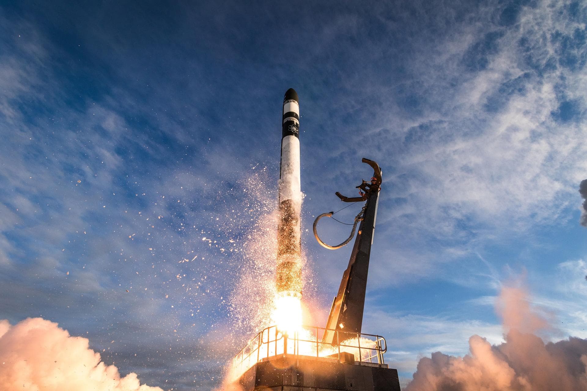 Rocket lifting off from launch pad with flames and exhaust