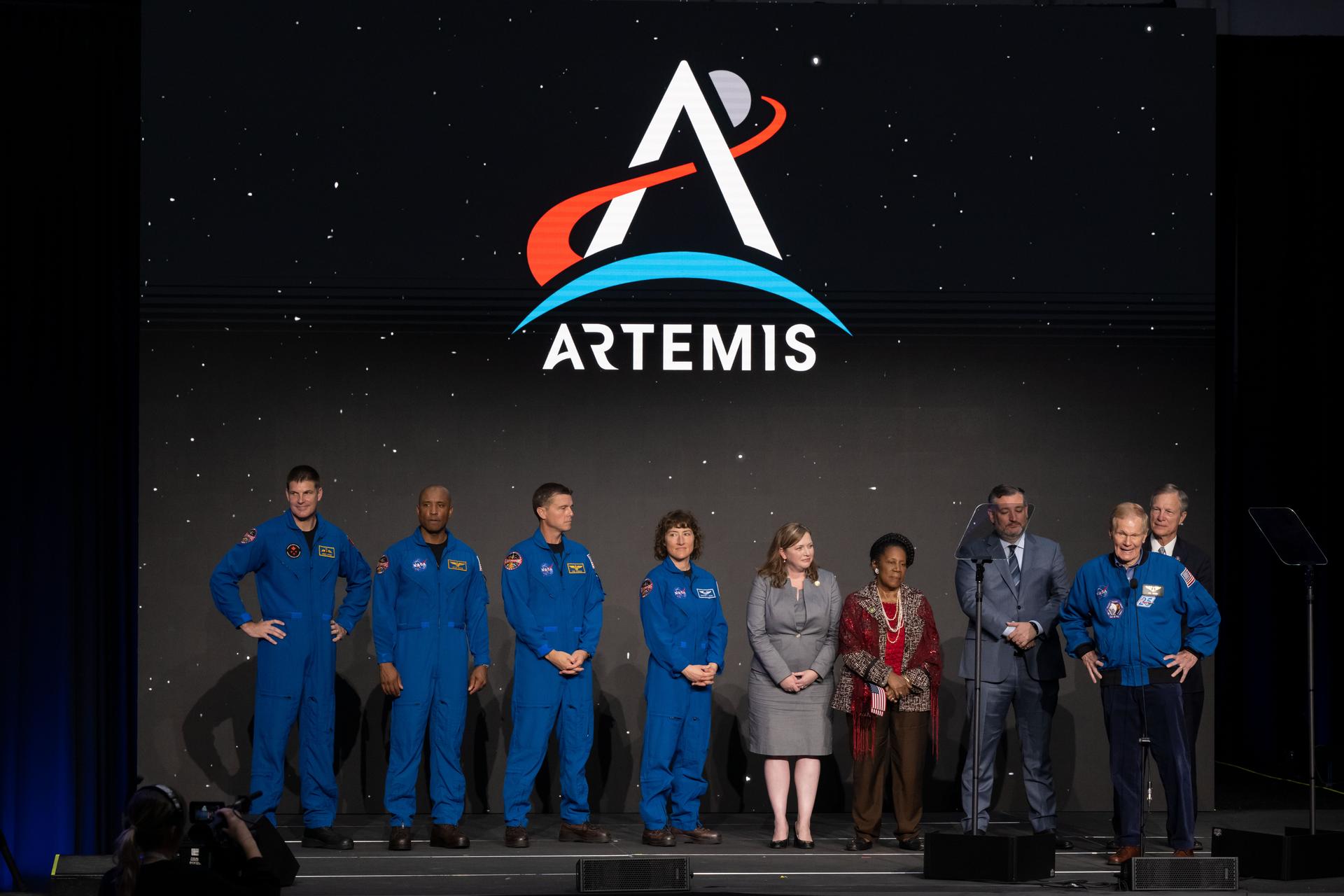 The four Artemis II crew members in their orange Orion flight suits — Reid Wiseman, Victor Glover, Christina Koch, and Jeremy Hansen