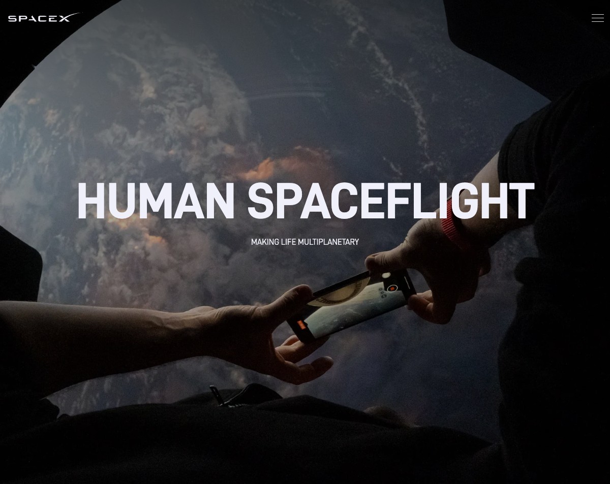 SpaceX Human Spaceflight — Astronaut photographing Earth from Dragon's cupola window